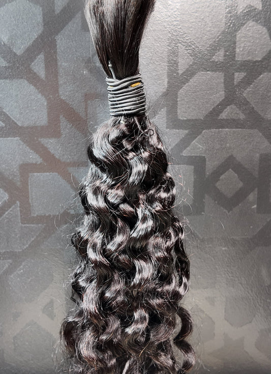 Braided hair extension against a textured gray background